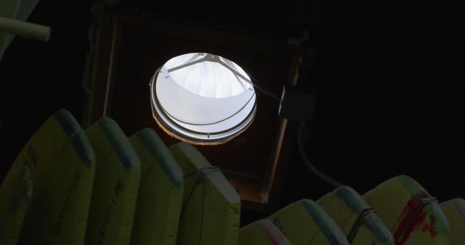 A fan spinning on the roof of a warehouse