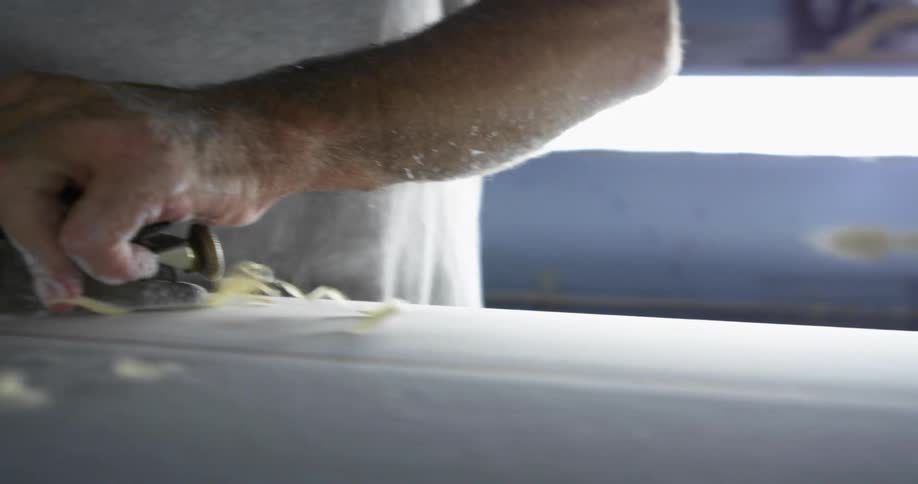A man working on a surfboard