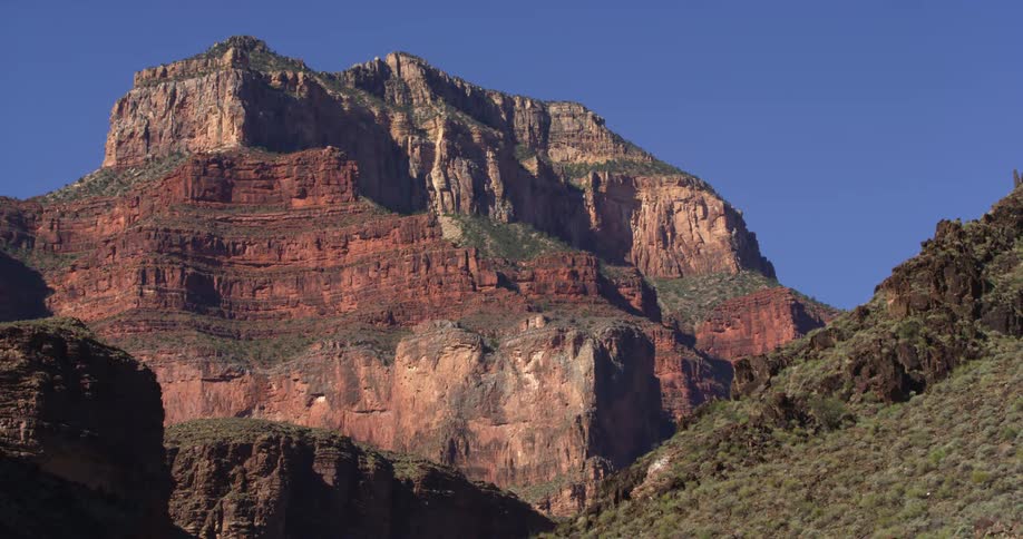 Classic layers of the Grand Canyon of the Colorado River as seen in morning light with a brilliant blue sky before setting off on a great day of whitewater rafting and kayaking