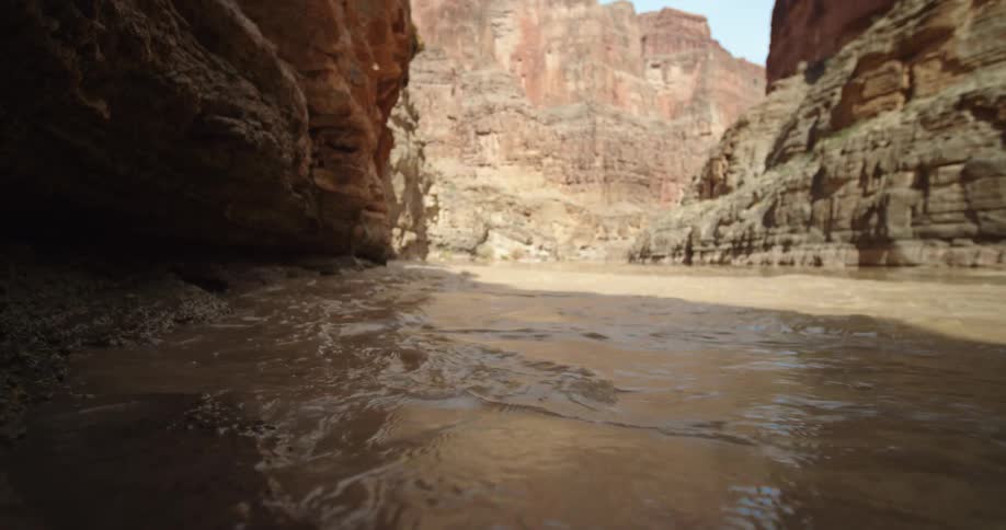 River level shot of water flowing down the Colorado River straight towards camera deep in Grand Canyon National Park