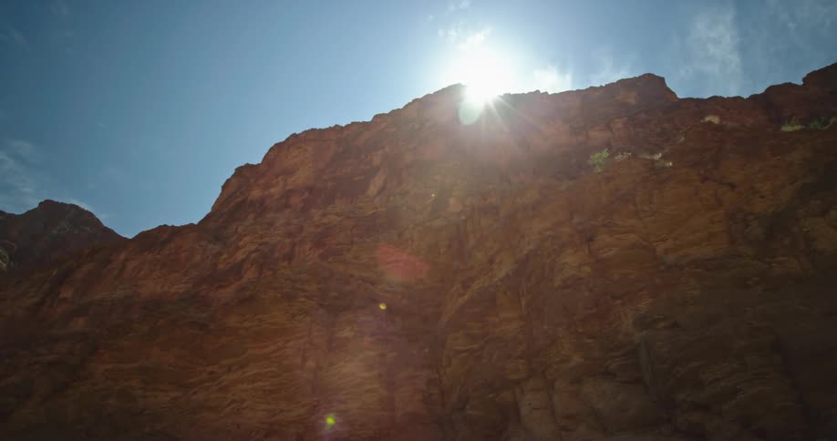 Looking up thousands of feet at the canyon rim deep in Grand Canyon National Park while whitewater rafting down the Colorado River
