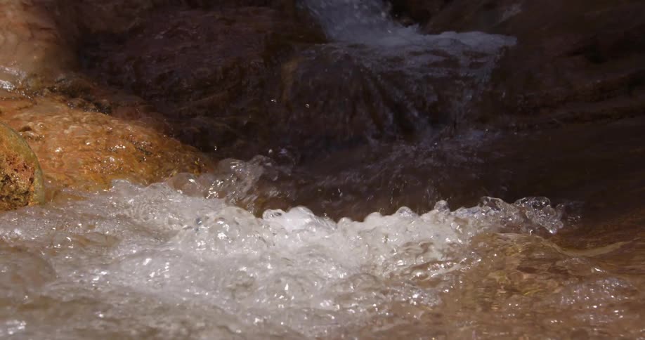 A burbling side canyon of clear fresh water cascading down the Grand Canyon National Park in Arizona