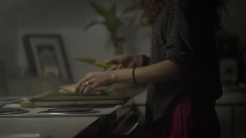 A girl opens a box and cuts the package inside open