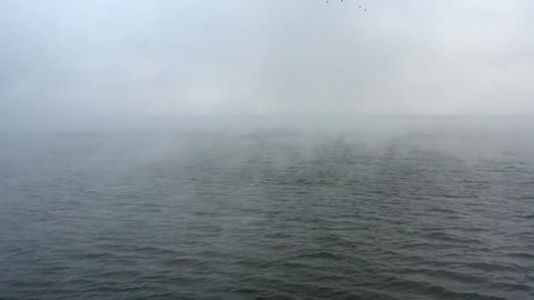 Mist floating above an ocean in the daytime