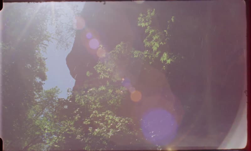 Rain falls while the sun is out over a canyon