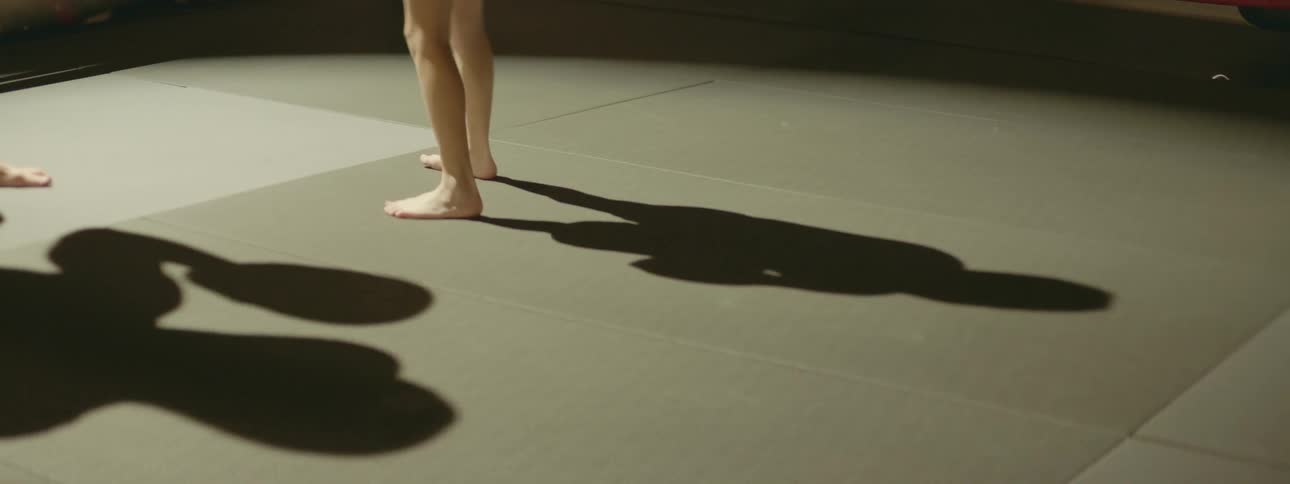 A woman is doing ballet in a room
