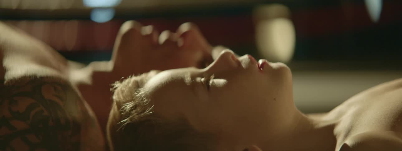 A man and a boy laying on the floor of a gym and breathing