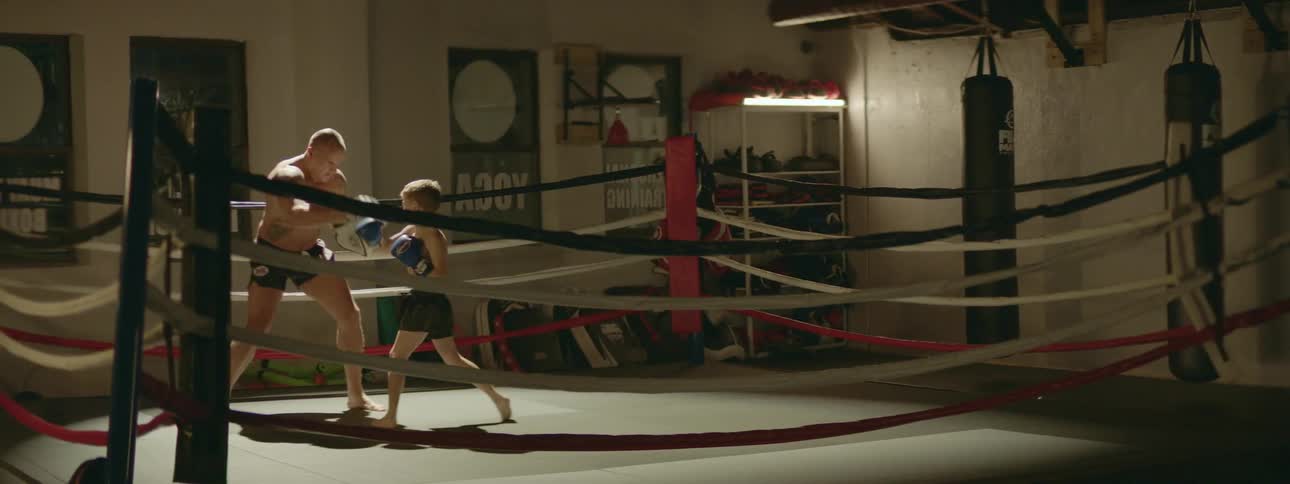 A father and son boxing in a ring