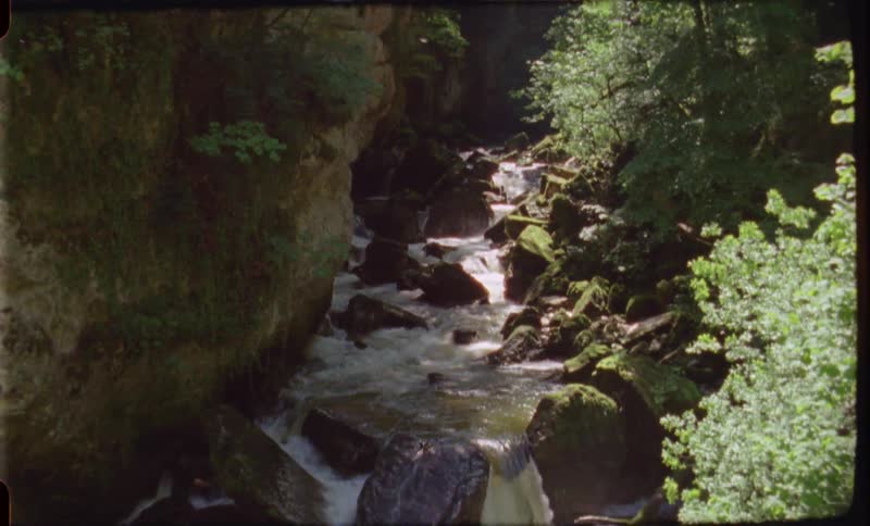 A waterfall and river in a valley