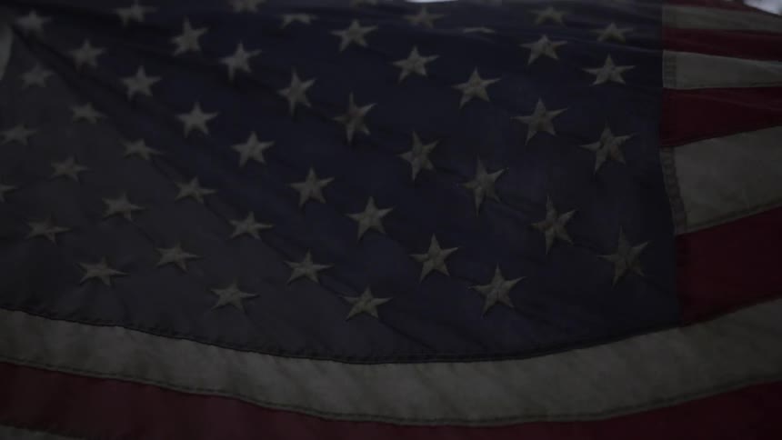An american flag is flowing in the wind