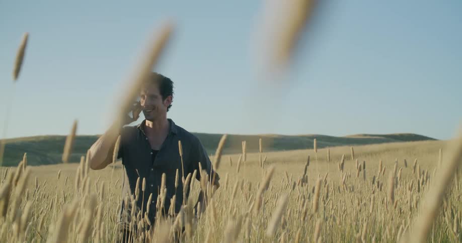 A man talking on his phone in a field