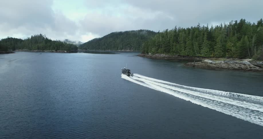 A boat is driving on the ocean water in spring