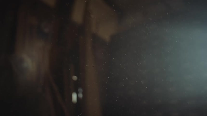 Lightning shines on the dust particles floating inside a dimly lit room