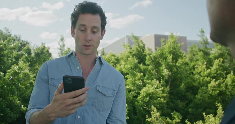 A man talking to a friend ask to check his phone