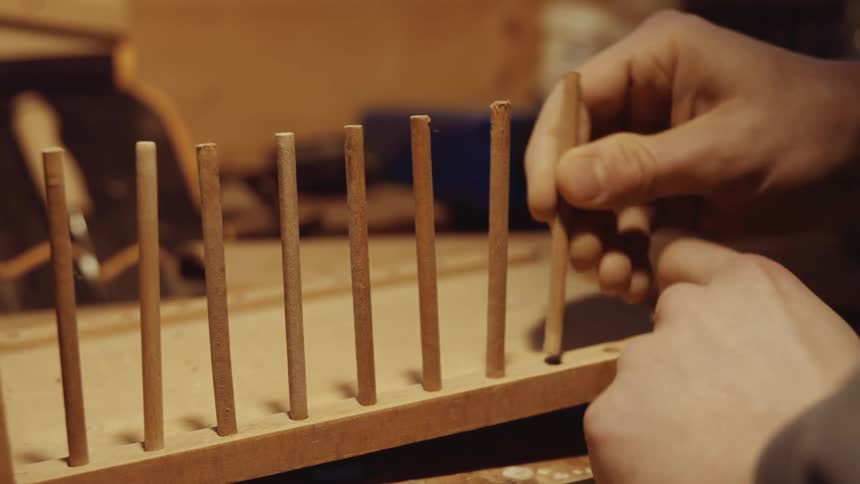 A person is putting together a wood model