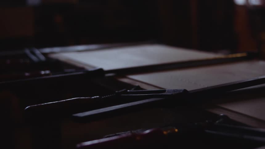 Objects sitting on a wood table in a dark room