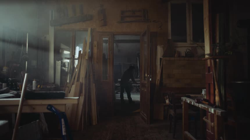 A silhouette of a person in a workshop