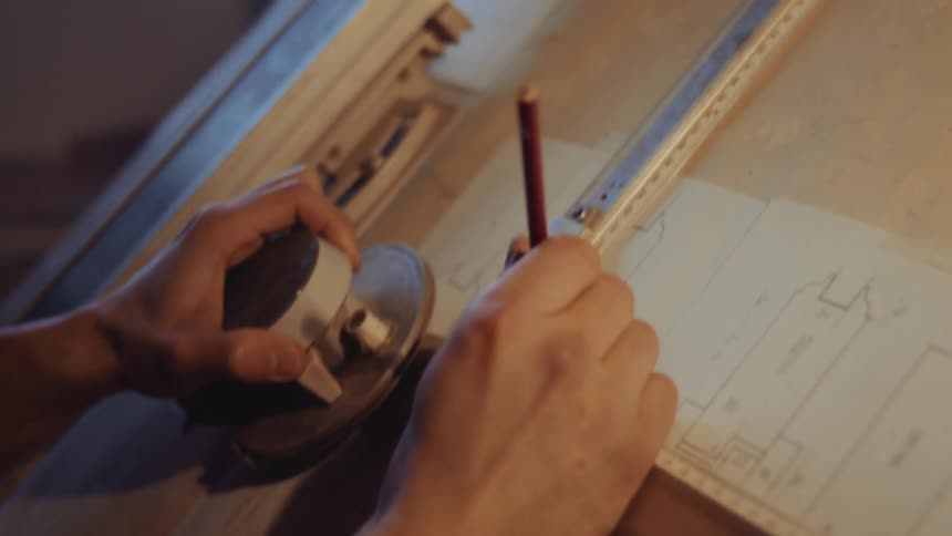 An architect draws a blueprint