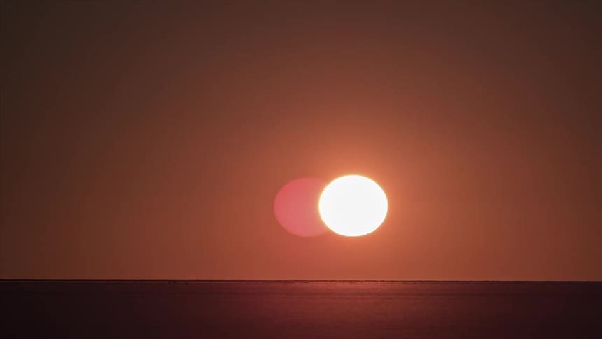 The sun setting in the horizon