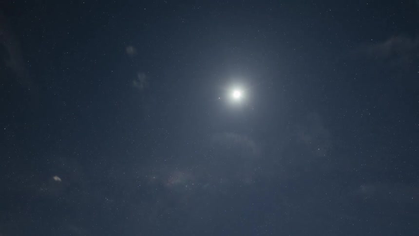 Time lapse of clouds moving through the sky at night