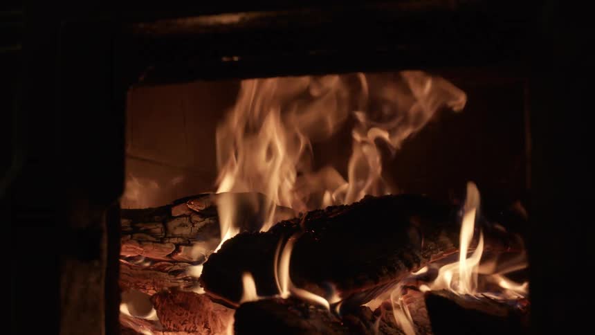 A fire burning inside a fireplace in a home