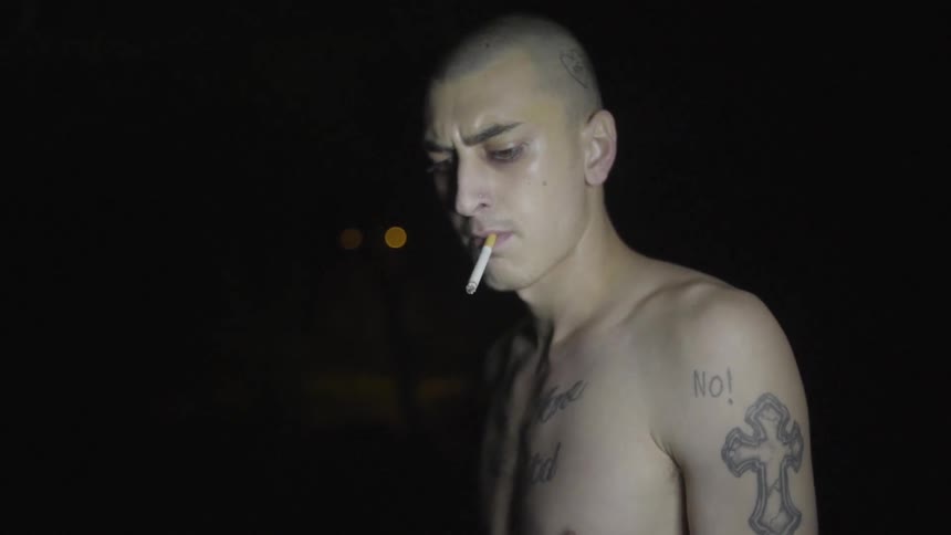 A man is smoking a cigarette