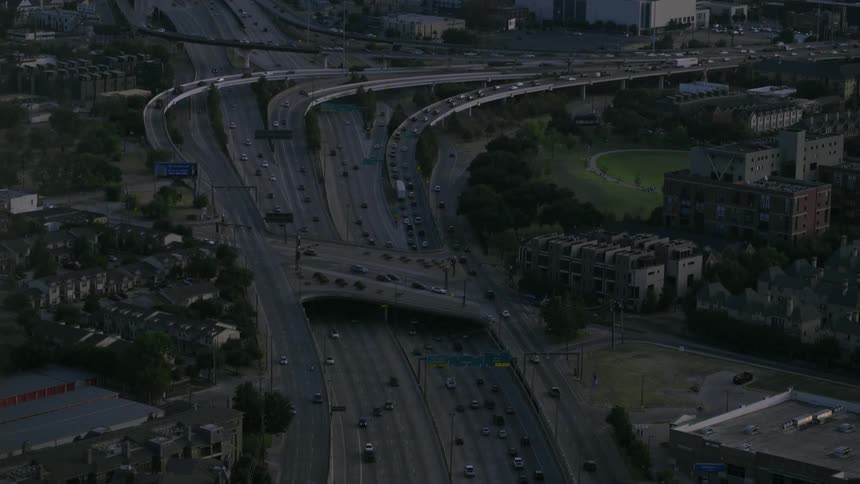 Cars traverse a freeway interchange at dusk or dawn