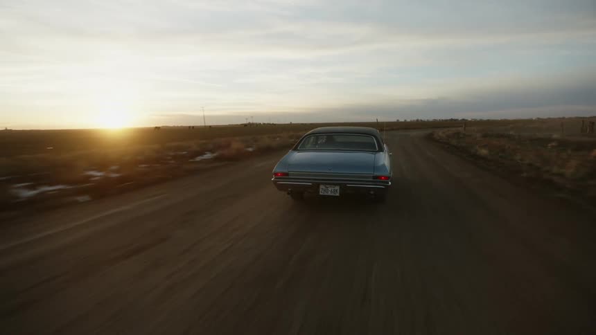 A vehicle is racing on the dirt road