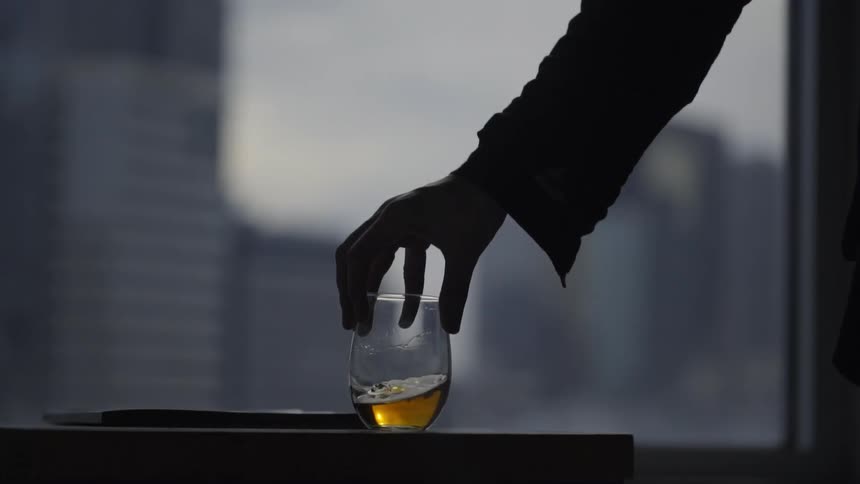 Hands put a glass of wine