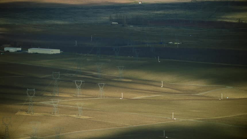 High tension power lines transmit vast amounts of electricity across the grid in to far away cities in this infrastructure shot