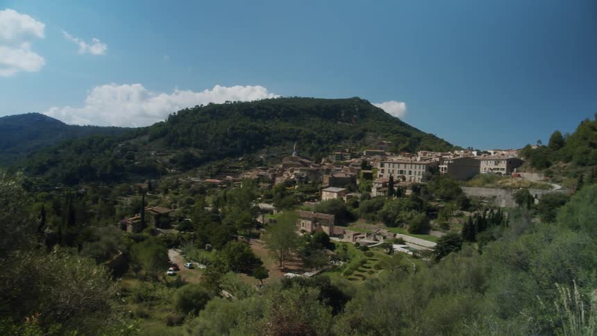 A man looks out over the green hills