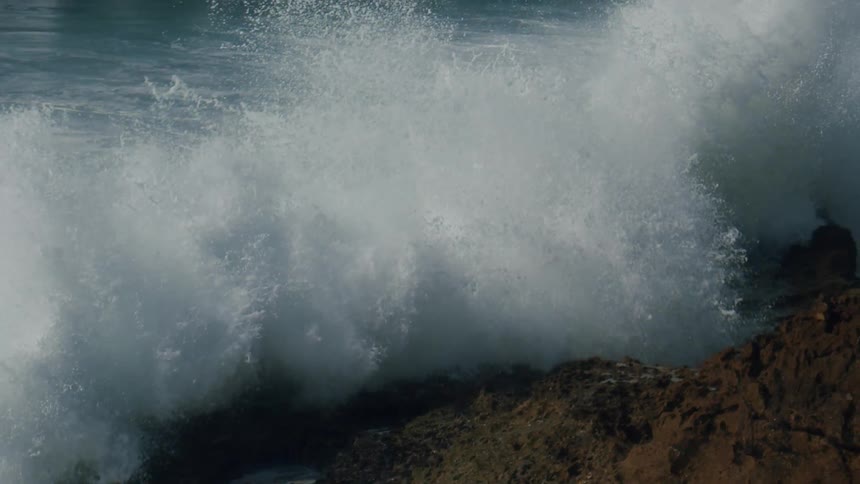 Waves crashing against the rocks on the shore