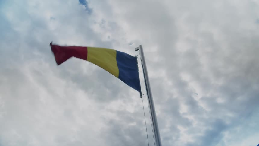 A raised flag blowing in the wind