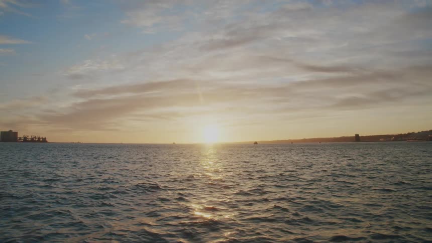 A view from a boat on a waterway of a sunset