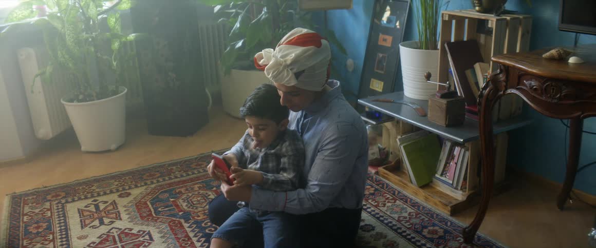 Mother showing her son her phone