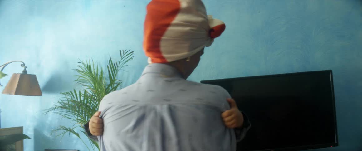 A mother holds her son in her arms as she turns in circles in a family room