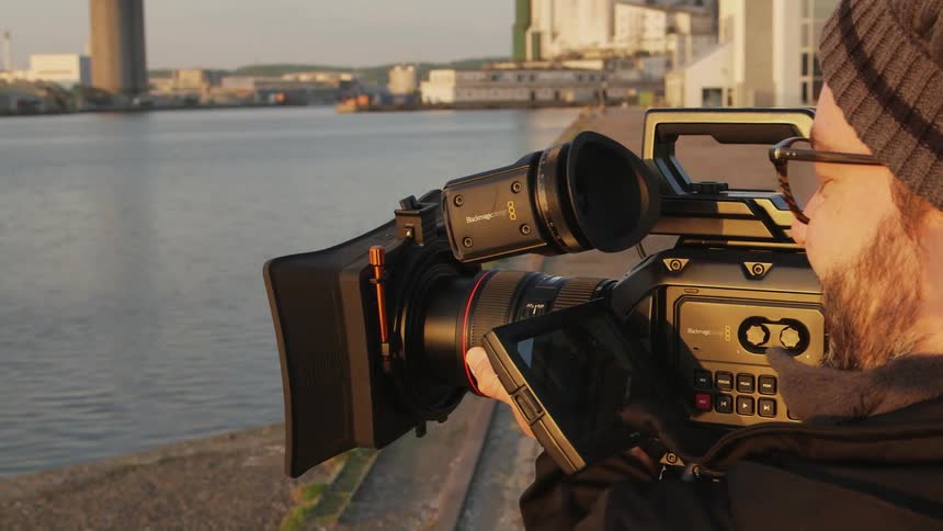 A man is filming the water before him