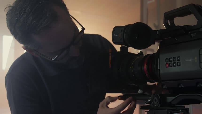 A man is checking a camera
