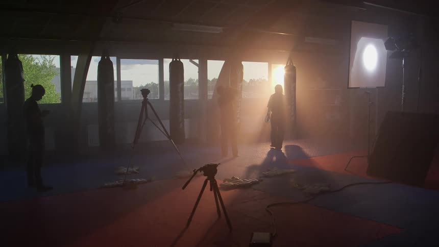 Person hitting punching bag as others look on