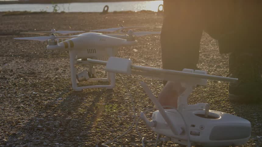 Man prepares two drones