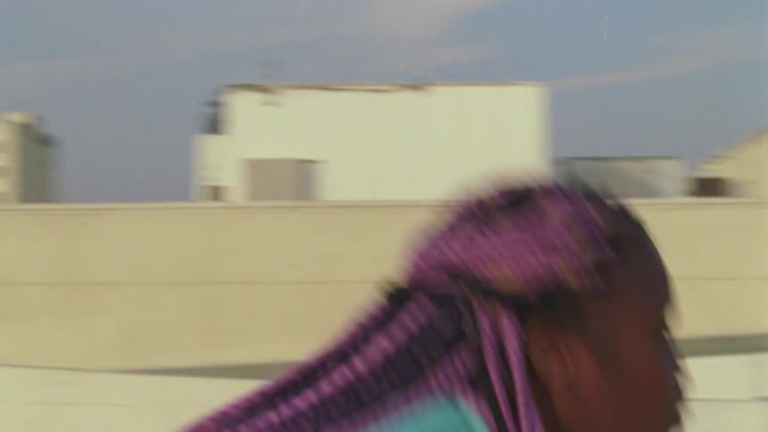 A woman is dancing in a downtown city during the day