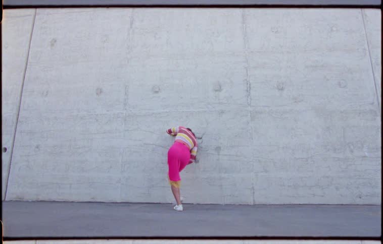 A woman is dancing outdoors in spring