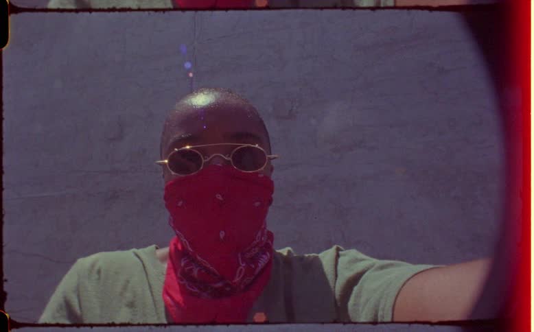 Footage of a person wearing a scarf outdoors is displayed