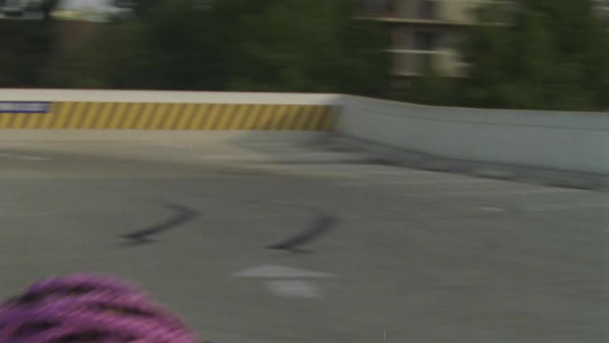 A woman is dancing on the roof parking lot