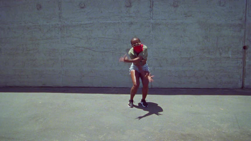 A teenage girl dances outside