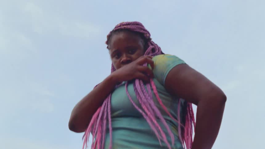 A teenage girl dances outside