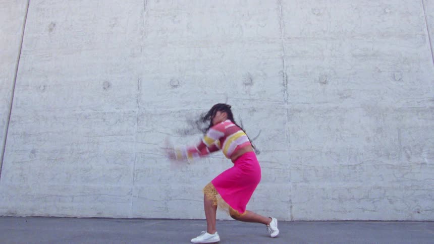 A woman dancing around outdoors