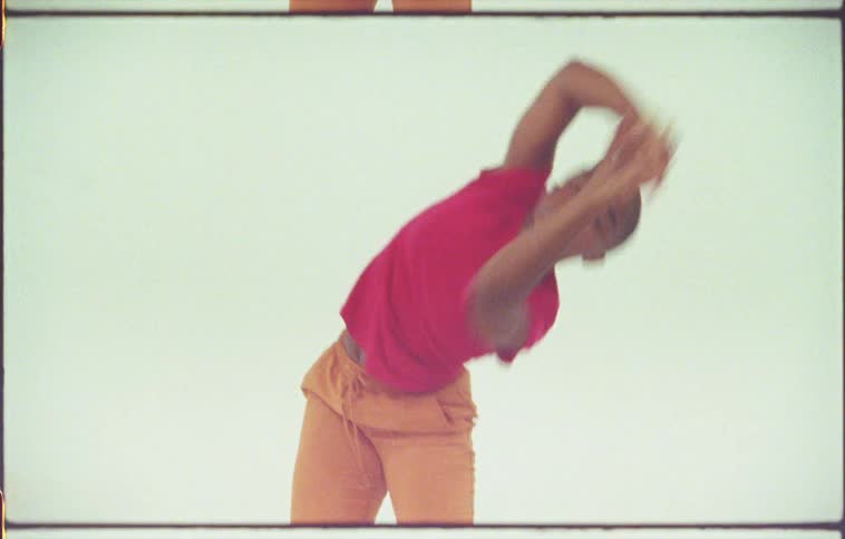 A woman performs a modern dance with large gestures and movements