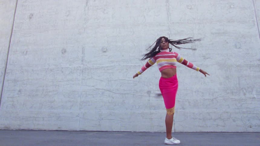 A woman that is dancing outdoors