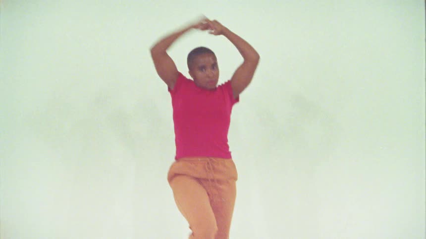 Woman dancing in white room